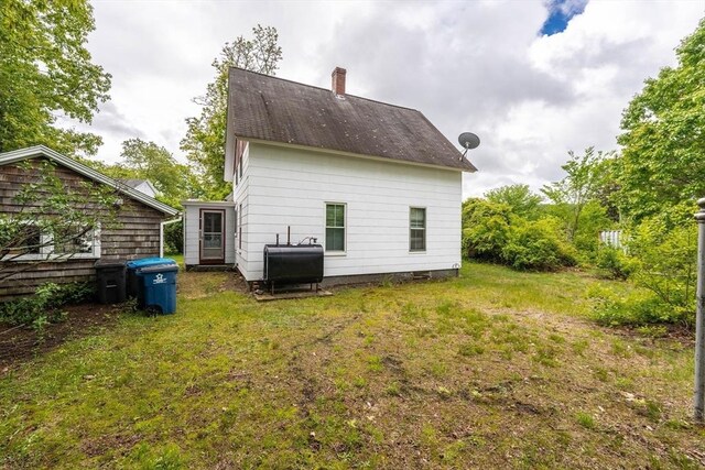6 Oak St, Monson, MA 01057 - rear view of house with heating fuel, a chimney, and a lawn