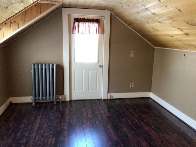 additional living space with lofted ceiling, dark hardwood / wood-style floors, radiator heating unit, and wood ceiling