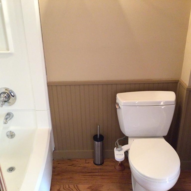 bathroom with wood-type flooring and toilet