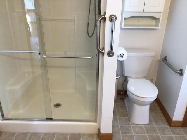 bathroom with toilet and an enclosed shower