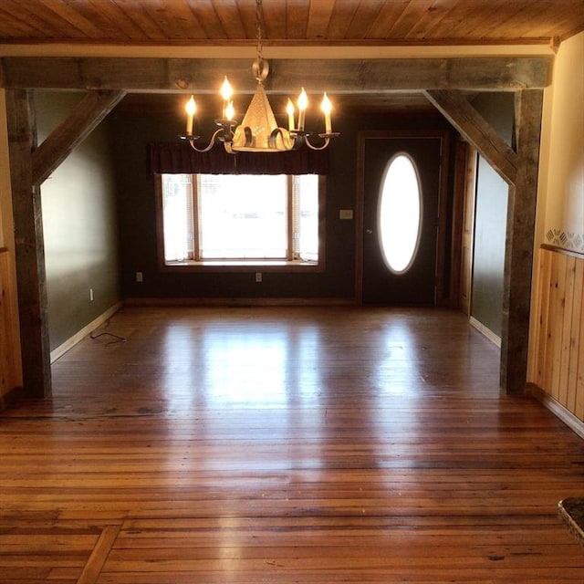 entrance foyer with dark wood-type flooring, a chandelier, and wooden ceiling