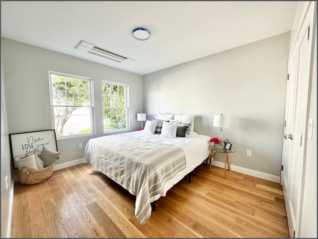 bedroom with hardwood / wood-style floors