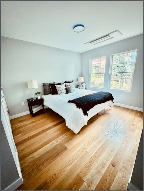 bedroom with hardwood / wood-style floors