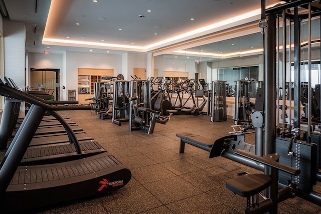 workout area featuring a tray ceiling