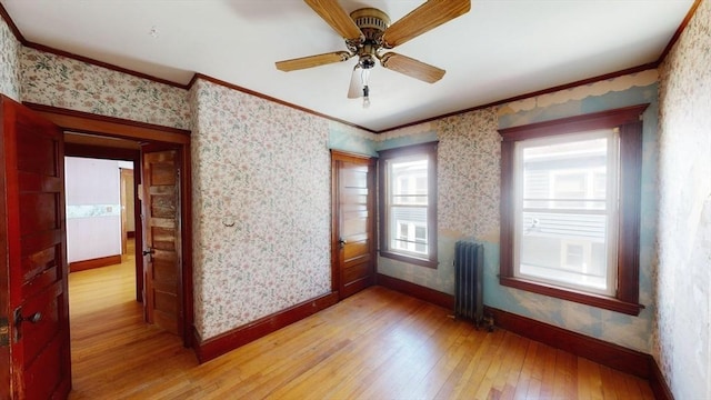 15-17 Brockton Ave, Haverhill, MA 01830 - unfurnished room with radiator, light wood-type flooring, crown molding, baseboards, and wallpapered walls