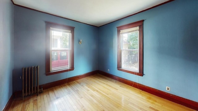 15-17 Brockton Ave, Haverhill, MA 01830 - spare room featuring radiator heating unit, ornamental molding, light wood-style floors, and healthy amount of natural light