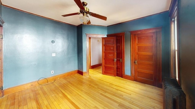 15-17 Brockton Ave, Haverhill, MA 01830 - spare room with baseboards, hardwood / wood-style floors, radiator, ceiling fan, and crown molding