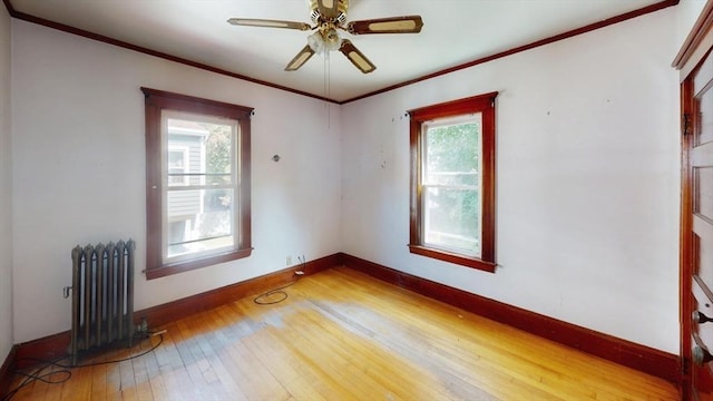 15-17 Brockton Ave, Haverhill, MA 01830 - spare room featuring radiator, light wood-style floors, baseboards, a ceiling fan, and ornamental molding