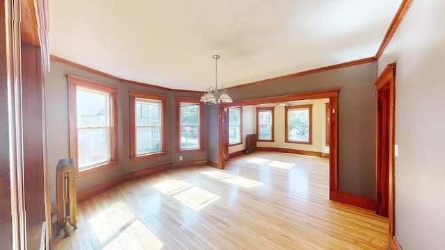 15-17 Brockton Ave, Haverhill, MA 01830 - unfurnished dining area with healthy amount of natural light, baseboards, crown molding, a chandelier, and light wood-type flooring