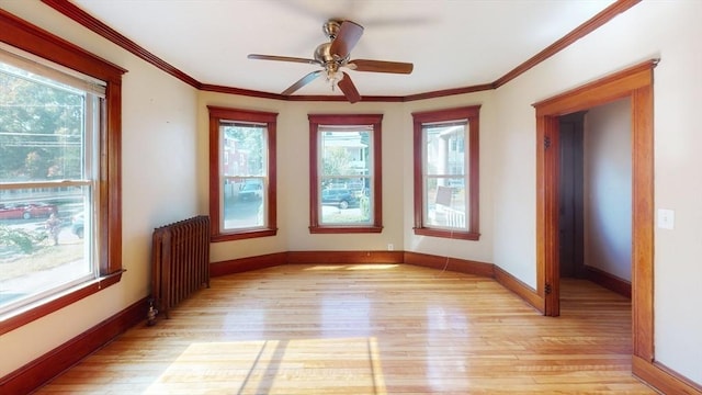 15-17 Brockton Ave, Haverhill, MA 01830 - empty room featuring radiator, light wood-style flooring, baseboards, ceiling fan, and ornamental molding