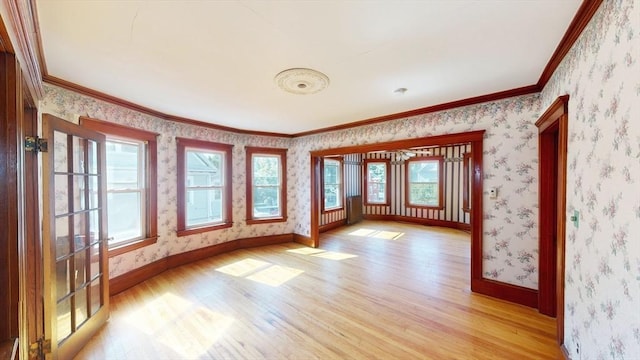 15-17 Brockton Ave, Haverhill, MA 01830 - empty room with light wood finished floors, baseboards, wallpapered walls, and ornamental molding