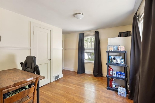 office area with light wood-type flooring and baseboards