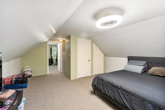 bedroom with lofted ceiling and light colored carpet