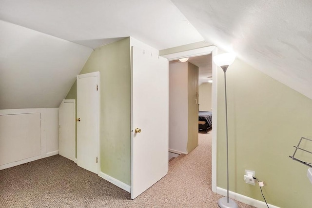 bonus room featuring light carpet and lofted ceiling