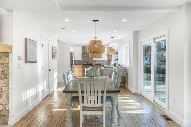 dining space featuring plenty of natural light and light wood-type flooring