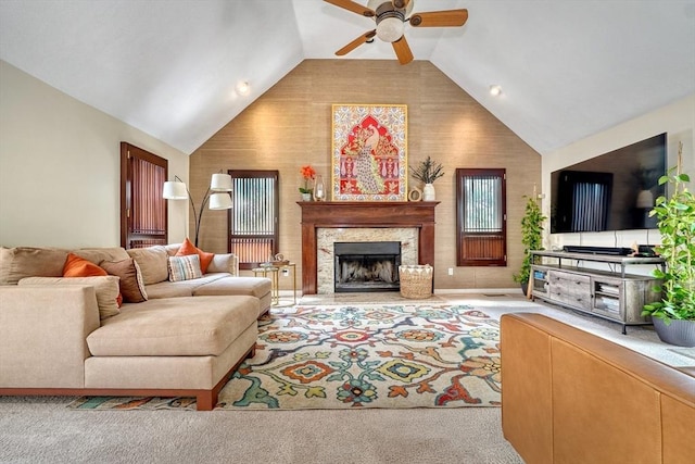 living room featuring ceiling fan, lofted ceiling, and a fireplace