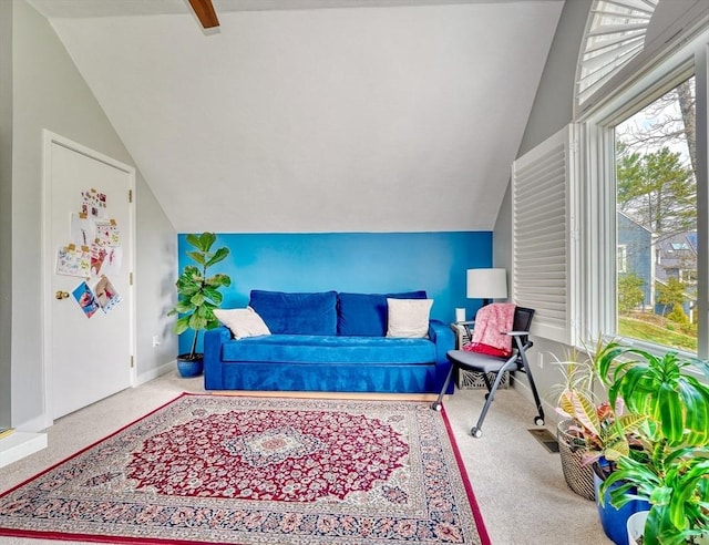 living area featuring carpet, vaulted ceiling, and a healthy amount of sunlight