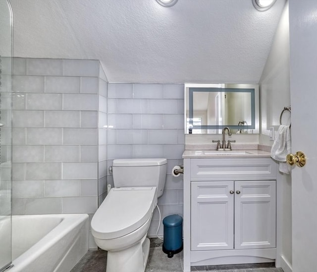 bathroom featuring vanity, a textured ceiling, and toilet