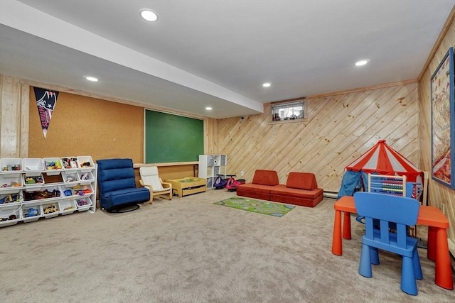rec room with carpet floors, wood walls, and recessed lighting