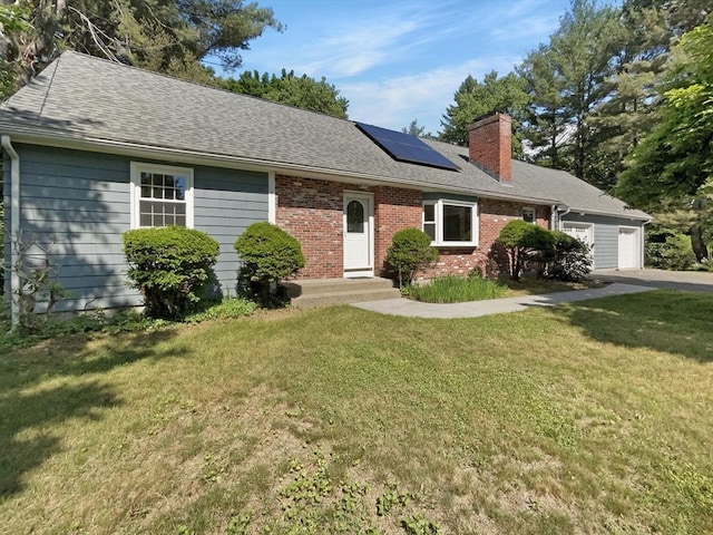 single story home with solar panels, a garage, and a front lawn