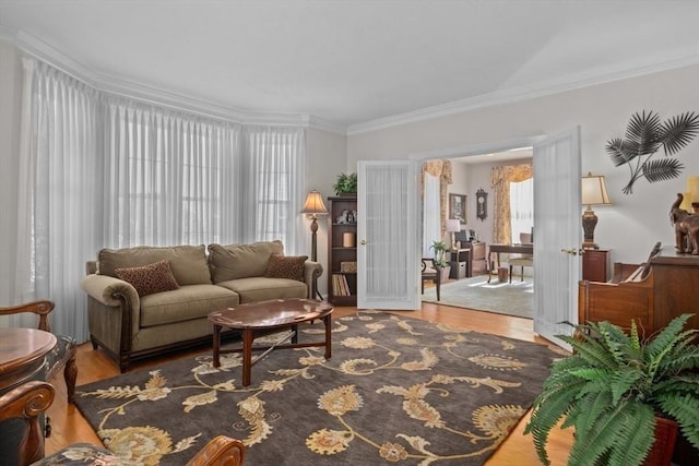 living room featuring wood-type flooring and ornamental molding