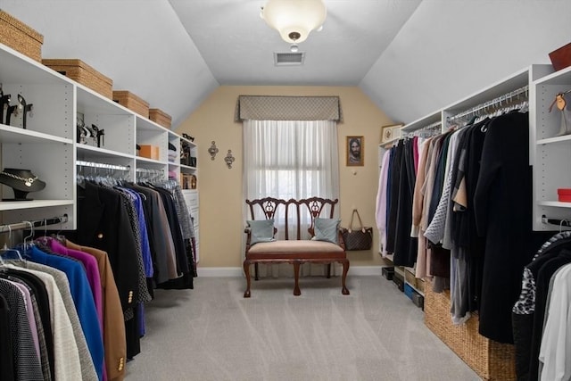 spacious closet featuring light carpet and vaulted ceiling