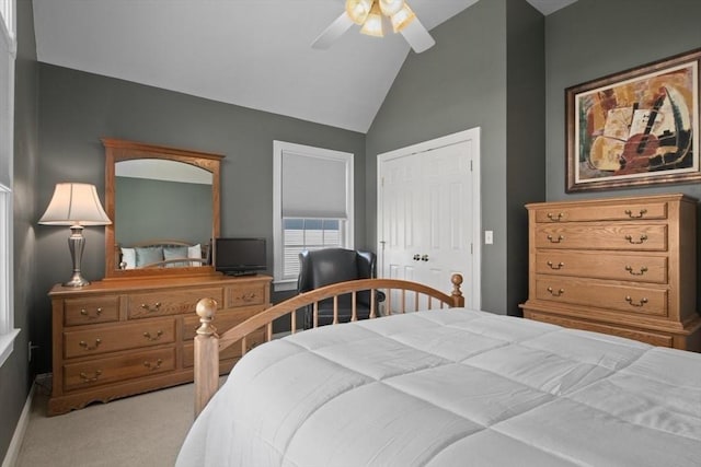 bedroom with light carpet, vaulted ceiling, a closet, and ceiling fan