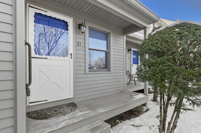 view of snow covered property entrance