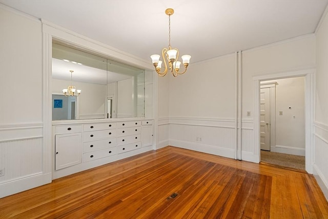 179 Rawson Unit 2, Brookline, MA 02445 - spare room with a chandelier, hardwood / wood-style flooring, and a decorative wall