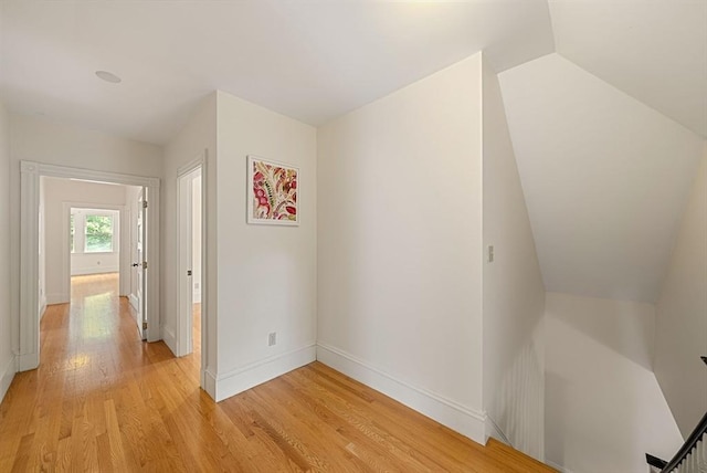 179 Rawson Unit 2, Brookline, MA 02445 - hallway featuring light wood-type flooring, baseboards, an upstairs landing, and lofted ceiling