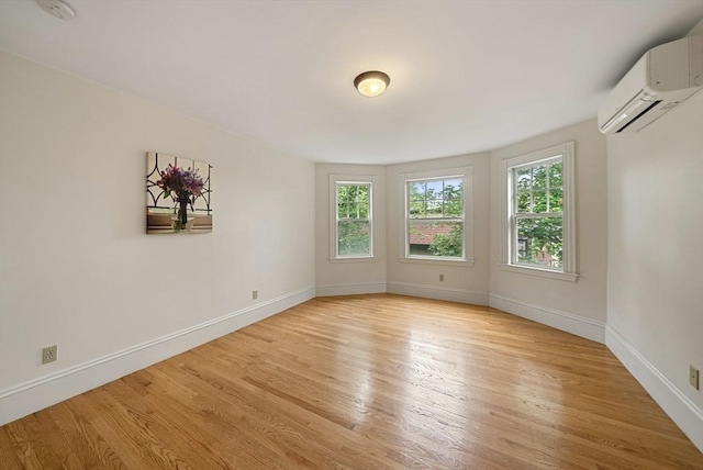 179 Rawson Unit 2, Brookline, MA 02445 - spare room featuring a wall mounted air conditioner, plenty of natural light, light wood-style floors, and baseboards