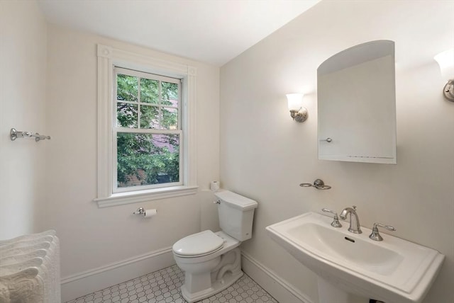 179 Rawson Unit 2, Brookline, MA 02445 - bathroom with toilet, a sink, baseboards, and tile patterned floors