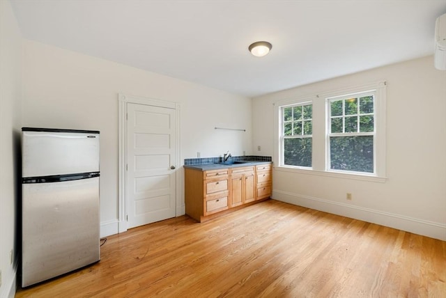 179 Rawson Unit 2, Brookline, MA 02445 - kitchen with freestanding refrigerator, a sink, light wood-style floors, and baseboards