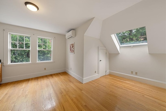 179 Rawson Unit 2, Brookline, MA 02445 - additional living space with a wall mounted AC, light wood-type flooring, baseboards, and a skylight