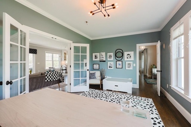 bedroom with ornamental molding, a notable chandelier, dark wood-style floors, and french doors
