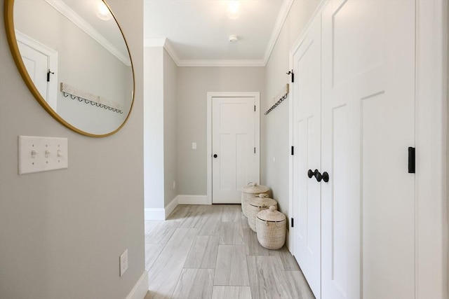 hall with crown molding and baseboards
