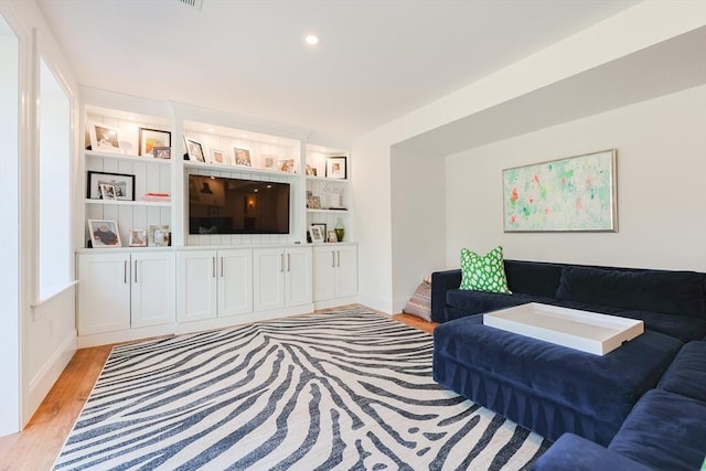 living area with recessed lighting and light wood-type flooring