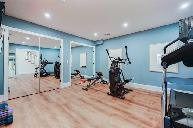 workout room featuring baseboards, recessed lighting, wood finished floors, and visible vents