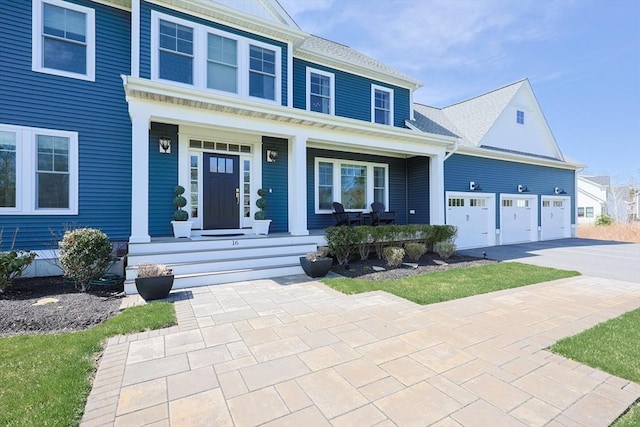 view of front facade featuring a porch, an attached garage, and concrete driveway