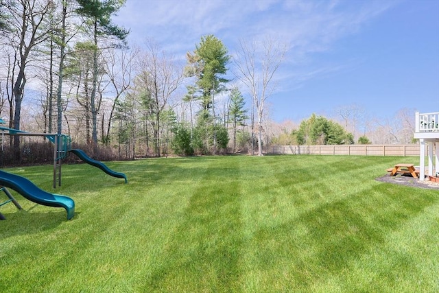 view of yard featuring a playground and fence