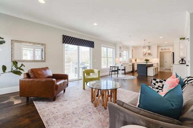 living area with recessed lighting, baseboards, ornamental molding, and dark wood-style floors