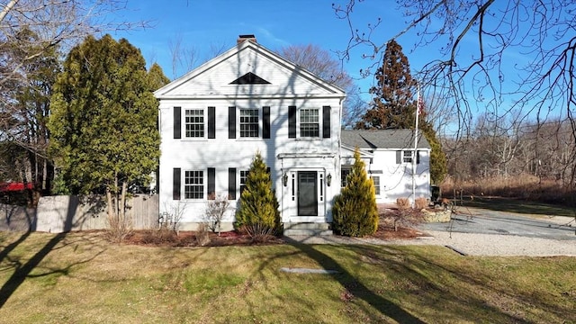 greek revival inspired property featuring a front yard