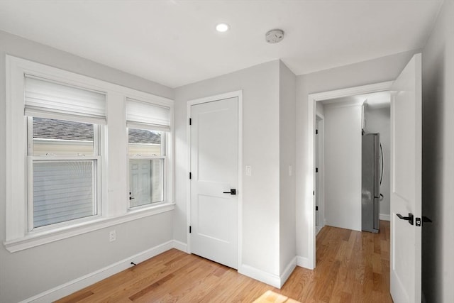 interior space with recessed lighting, baseboards, and light wood-style flooring