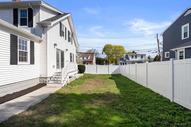 view of yard with a fenced backyard