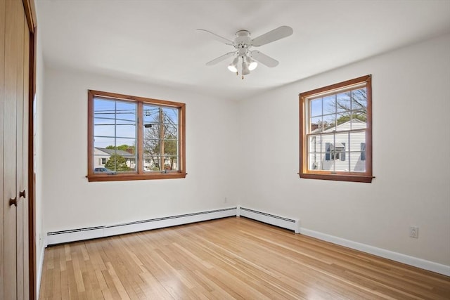 empty room with baseboards, ceiling fan, and wood finished floors