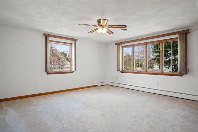 unfurnished room featuring a baseboard radiator, carpet floors, and plenty of natural light