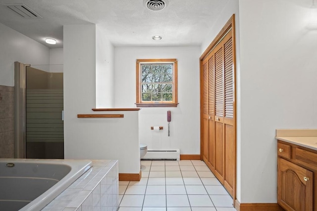 full bathroom featuring toilet, baseboard heating, visible vents, and a bath