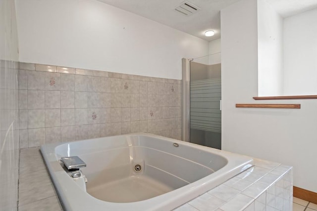 bathroom featuring visible vents and a jetted tub