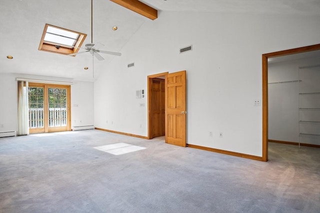 empty room with a skylight, light colored carpet, high vaulted ceiling, visible vents, and beamed ceiling
