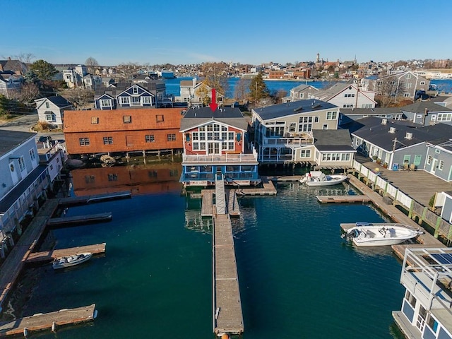 drone / aerial view featuring a water view and a residential view